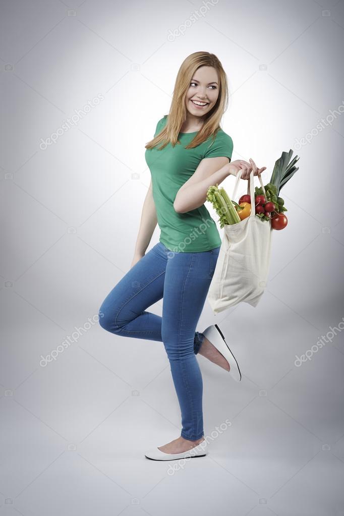 Woman with basket full of healthy food