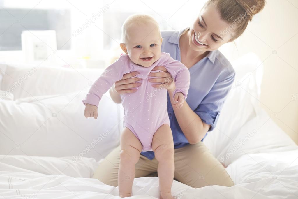 Young mother playing with baby