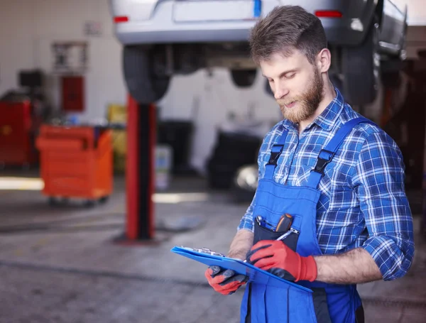 Mechanic checking orders