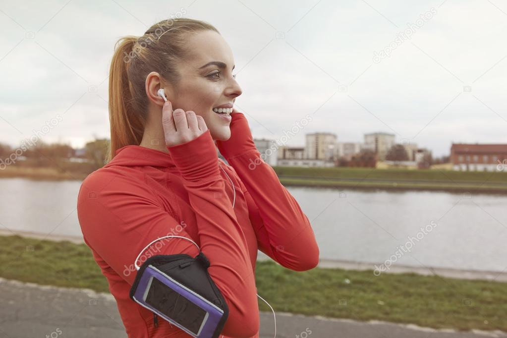 Woman training and listening to music