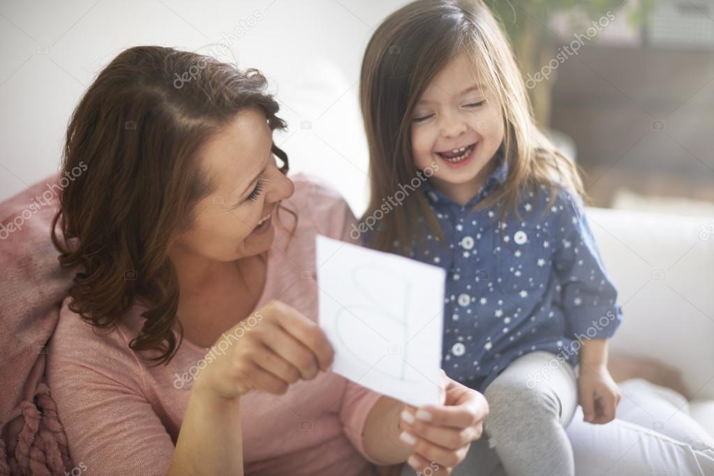 Little girl learning alphabet with mother