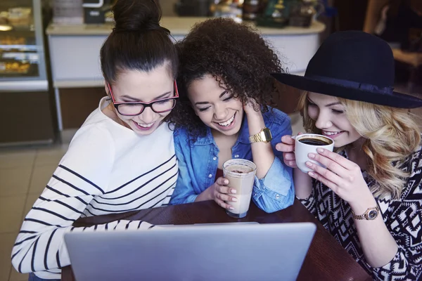 Groupe d'amis utilisant un ordinateur portable dans un café — Photo