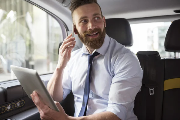 Successful businessman in cab — Stok fotoğraf