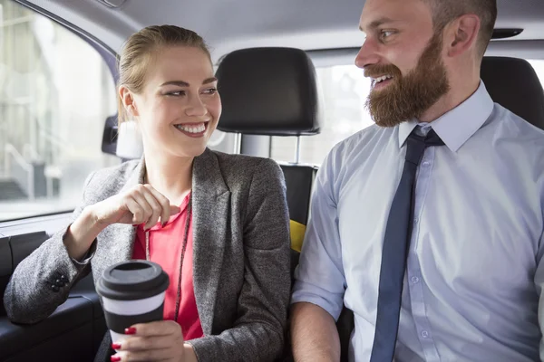 Successful business people in car with coffee — Stock Photo, Image