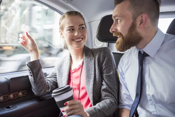 Successful business people in car with coffee — 스톡 사진