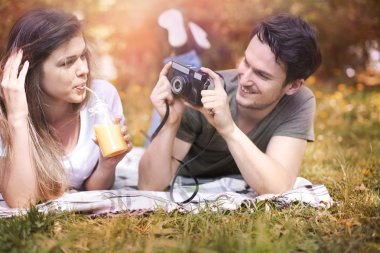 couple in love taking photo in park clipart