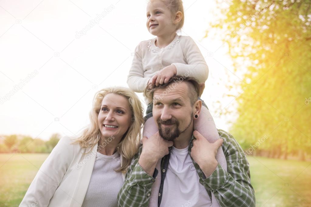 Happy family in park with daughter