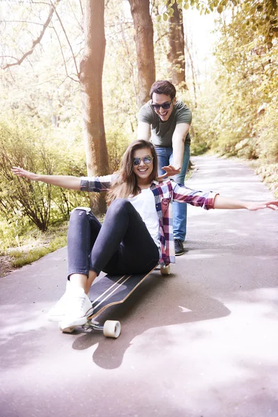 Junges Paar reitet Schlittschuh im Park — Stockfoto