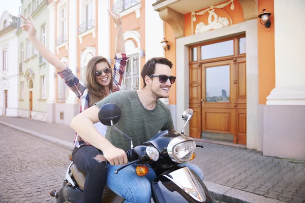 Young couple riding bike in city — Stock Photo, Image