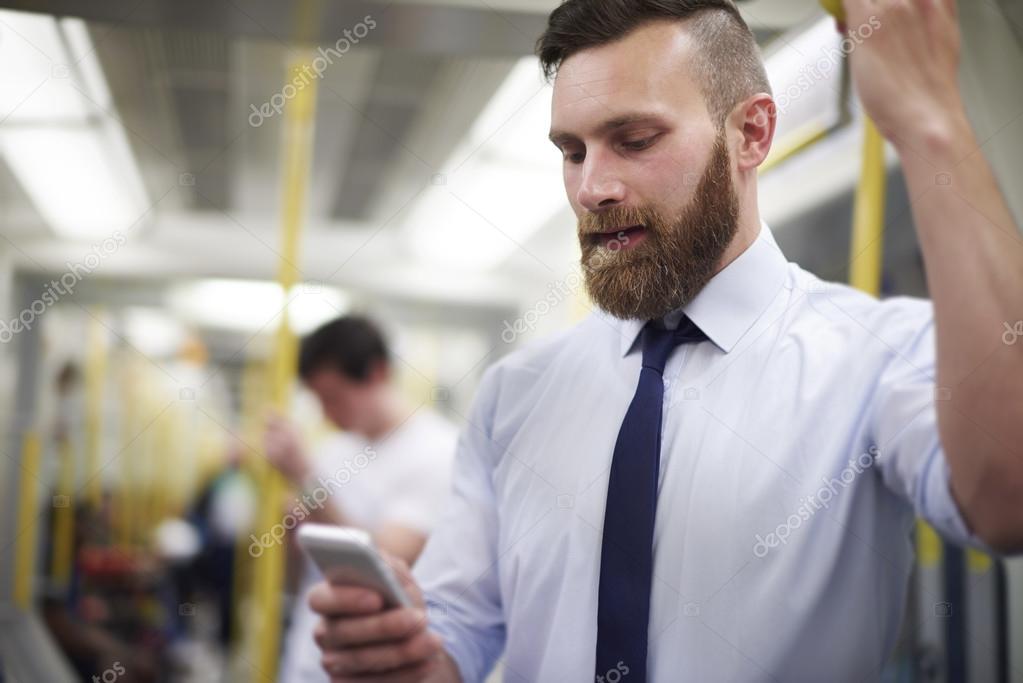 Businessman in subway with phone