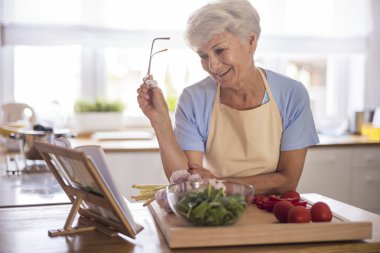 mature woman looking to recipe book clipart