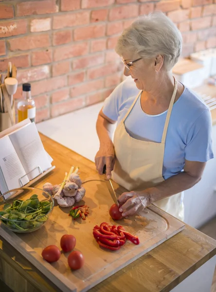 Mature woman preparing tasty food — Stock Photo, Image