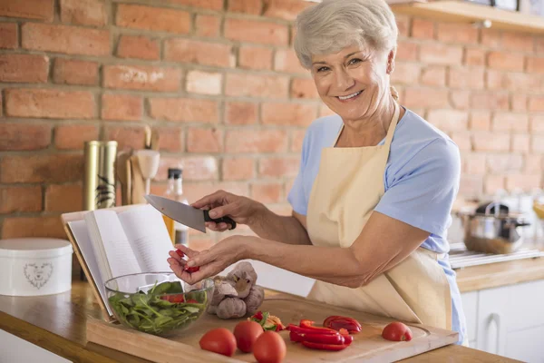 Reife Frau blickt in die Kamera und lächelt — Stockfoto