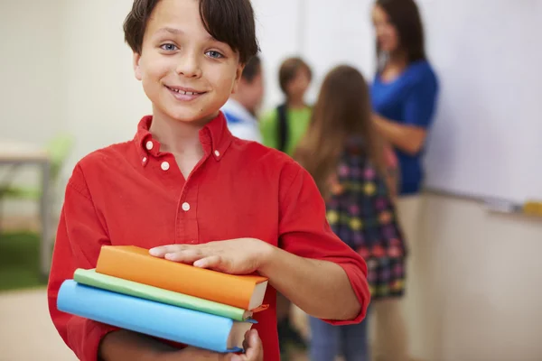 Boy standing with books primary school — Stock Photo, Image