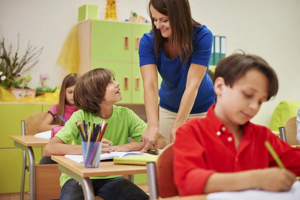 Teacher talks her pupil to correct mistake Royalty Free Stock Images