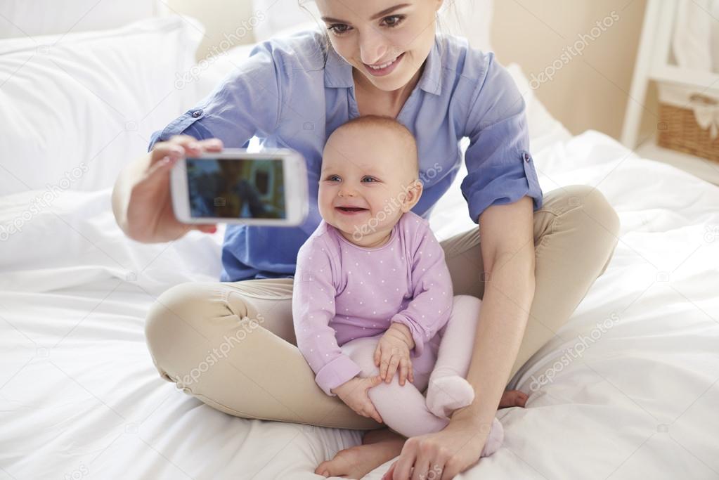 Mother with her baby taking selfie