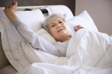 mature woman in bed clipart