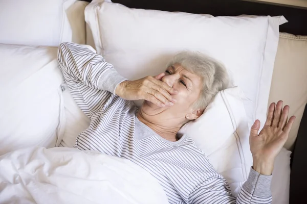 Mature woman in bed — Stock Photo, Image