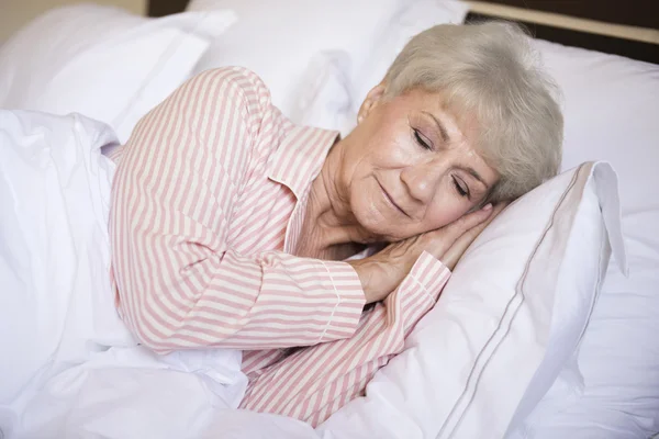 Mature woman in bed sleeping — Stock Photo, Image