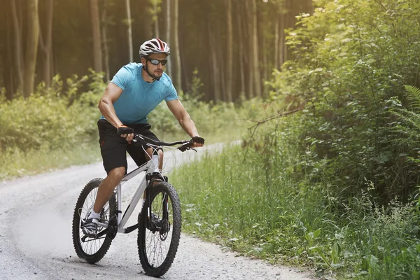 Pensive man riding down the hil — Stock Photo, Image