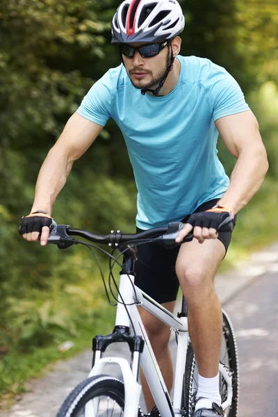 Serious man riding on bicycle. — Stock Photo, Image