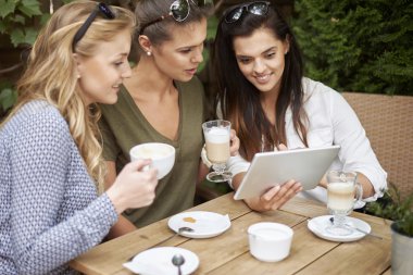 women spending time together with laptop