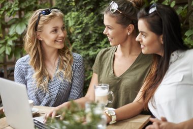 women spending time together with laptop