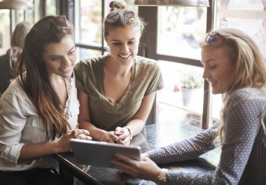 women spending time together with laptop