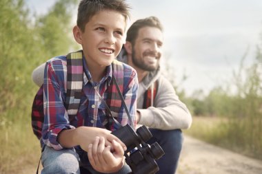 father and son with binoculars clipart