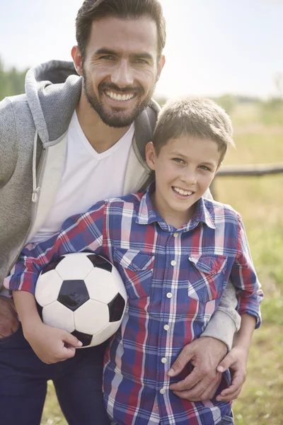 Father playing football with son