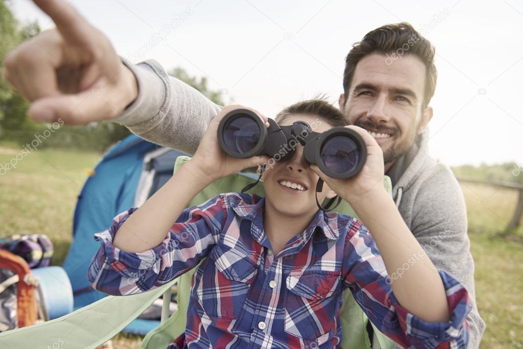 father and son with binoculars