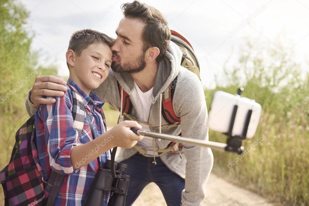 father and son taking selfie