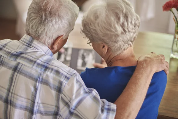 Senior couple looking photographs — Stock Photo, Image