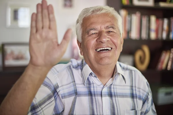 Senior man waving to the camera — Stock Photo, Image