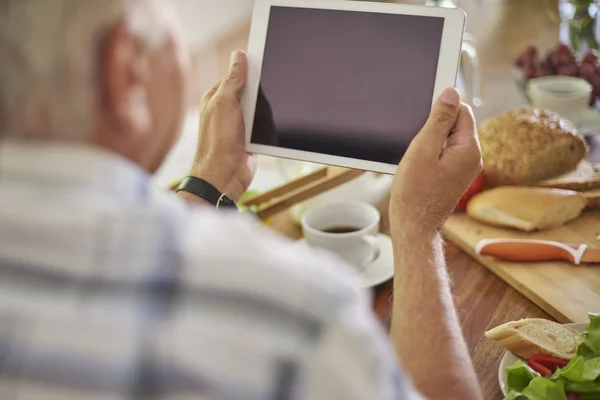 Homem sênior usando tablet digital — Fotografia de Stock