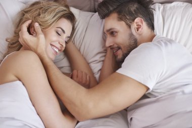 Happy couple in bed. clipart