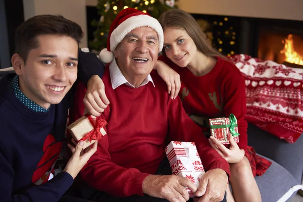 Nipotini che abbracciano nonno — Foto Stock