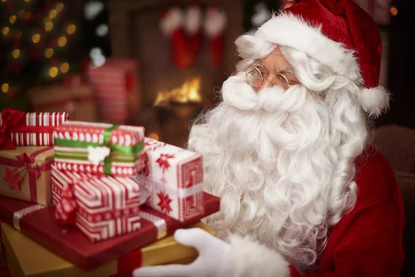 Santa Claus with heap of presents — Stock Photo, Image