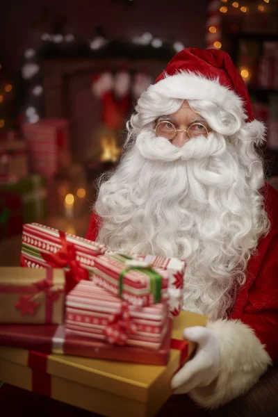 Santa Claus with pile of presents — Stock Photo, Image