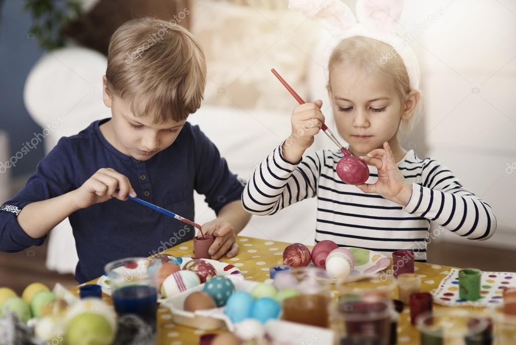 Children painting Easter eggs Stock Photo by ©gpointstudio 98328068