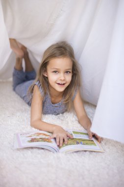 Cheerful girl reading book clipart