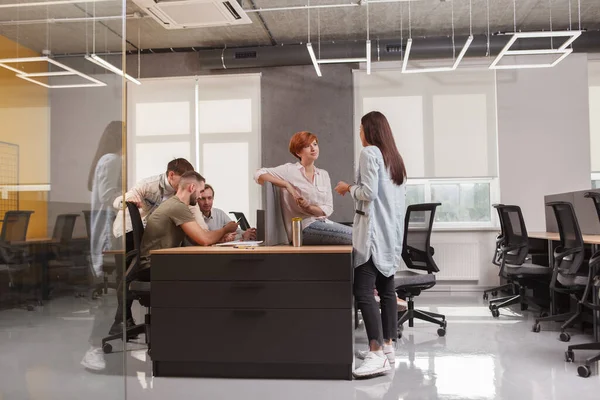 Young people working at modern open space office, copy space