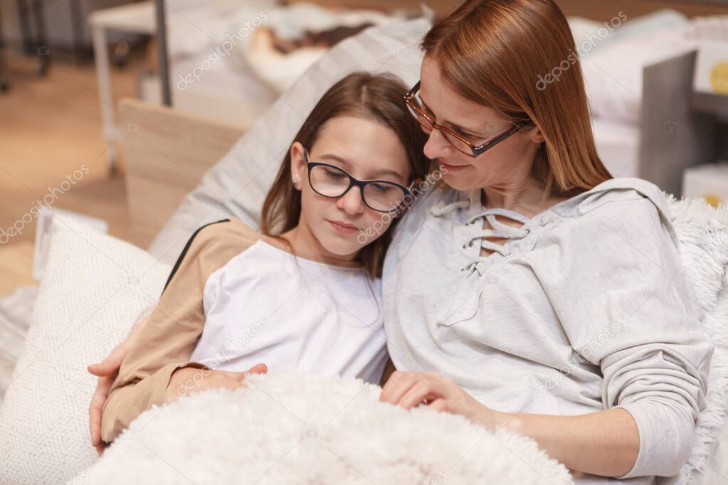 Loving mother comforting her upset teenage daughter