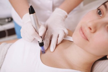 Cropped shot of a young woman receiving mesotherapy treatment by beautician clipart
