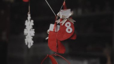 Evdeki küçük kırmızı Noel oyuncakları Noel Baba 'nın camında asılı.