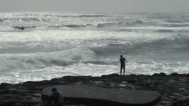 カブーパテン バダン インドネシア 2020年11月6日 大きな波と岩のある釣竿を持つインドネシアの漁師 — ストック動画