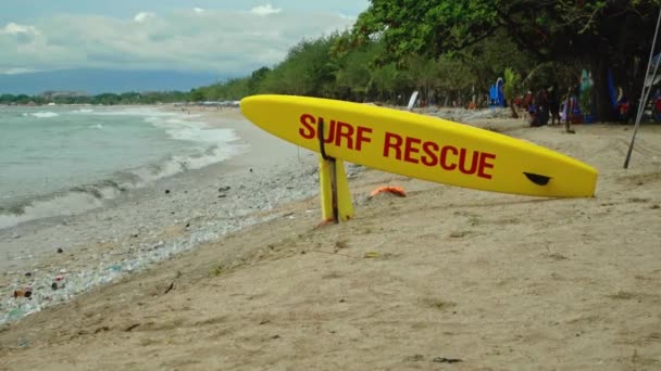 在巴厘岛的一个海滩上 黄色冲浪板上有红色文字的冲浪救援紧急救援 — 图库视频影像
