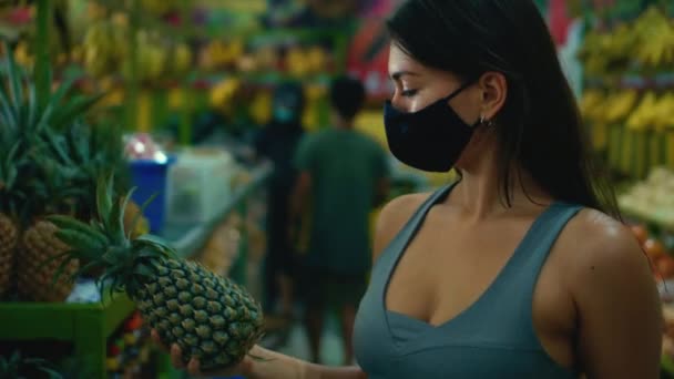 Young European Girl Chooses Organic Fruits Store Holding Pineapple Her — Stock Video