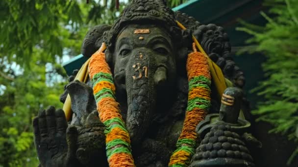 Old Stone Statue Ganesha Covered Moss Wreath Yellow Flowers His — Stock Video