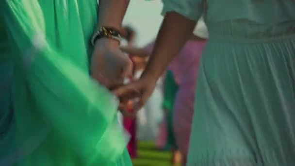 Mladé evropské dívky přátelé v šatech jít držet navzájem ruce v přírodě se zelenou trávou na pozadí